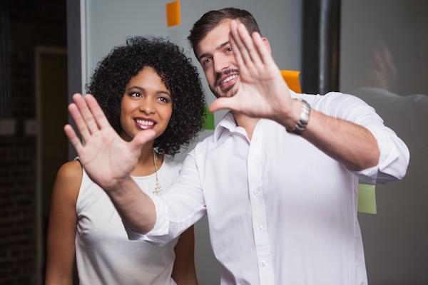 Man framing out a vision in the air to a woman