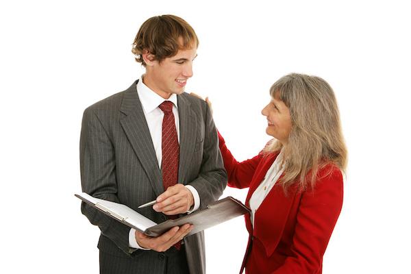 older woman smiling with hand on shoulder of a younger man