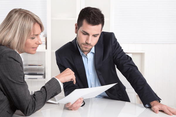 man and woman going over a paper