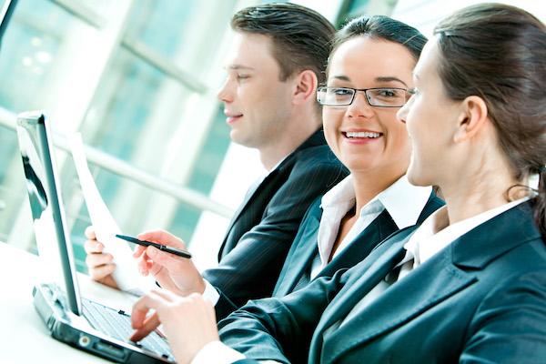 3 business people working with two woman smiling at each other