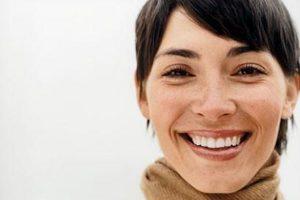 smiling woman in a cowl neck shirt