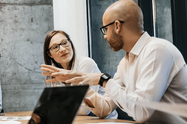 casual coworker man and woman talking intently