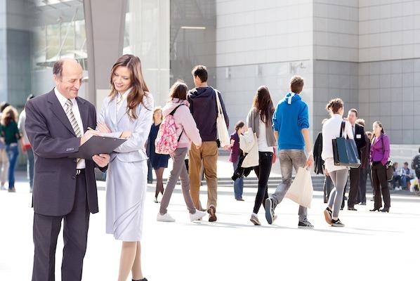 business people in a professional setting with two looking at something together