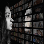 Woman staring at a wall of images of people