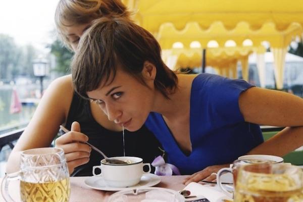 woman spitting in another woman's soup