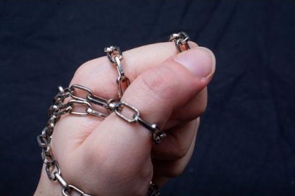 fist holding a metal chain