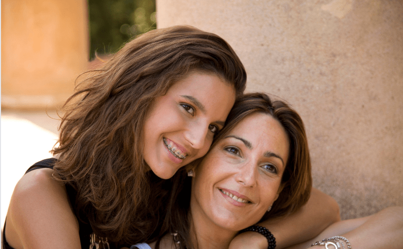 mother and teen daughter embracing