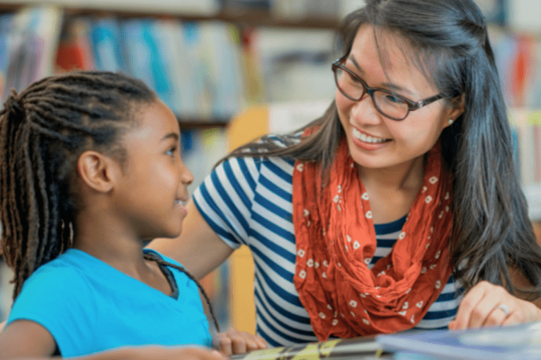 black girl student with asian woman teacher