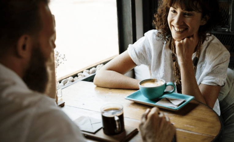 Woman and man talking at coffee shop