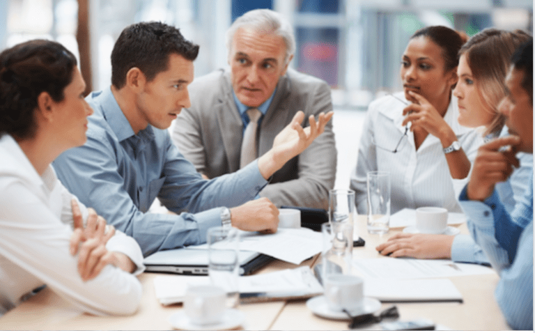 Business meeting all are intently listening to one man