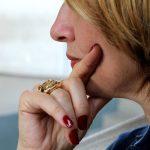 Woman looking pensive with hand on her chin
