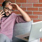 male employee stressed out on phone