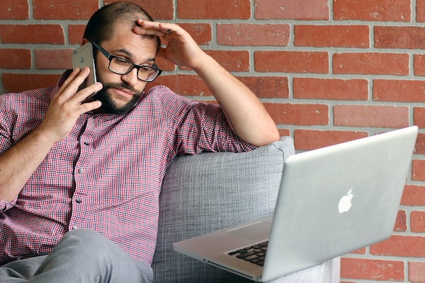 male employee stressed out on phone