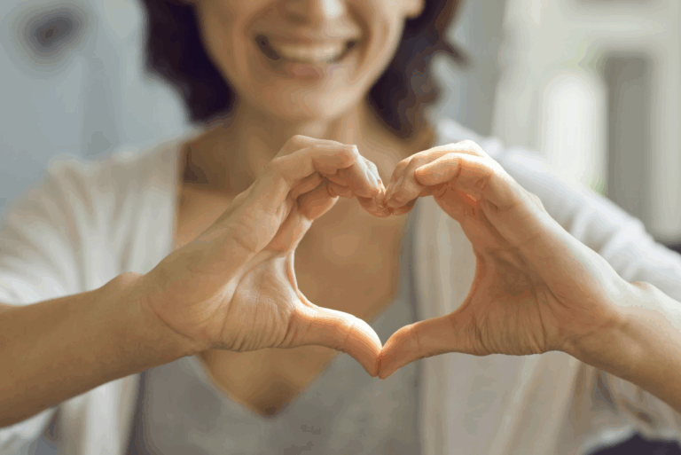 woman with hands in shape of a heart