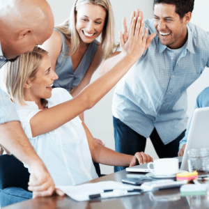group of excited coworkers giving high fives to each other