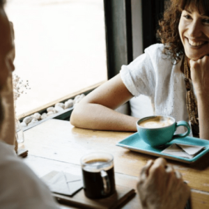 Woman and man talking at coffee shop
