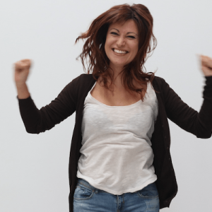 excited smiling woman jumps up and down with hands up