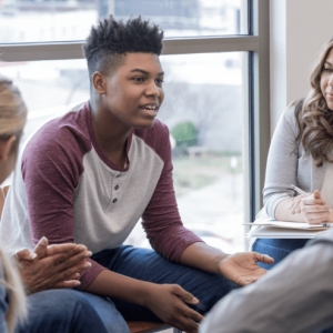 teens in a circle having a classroom meeting